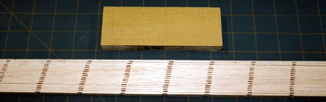 Cut the board into strips and block sand them to uniform width.