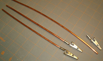 Soft wire is cut to length and soldered inside alligator clips.